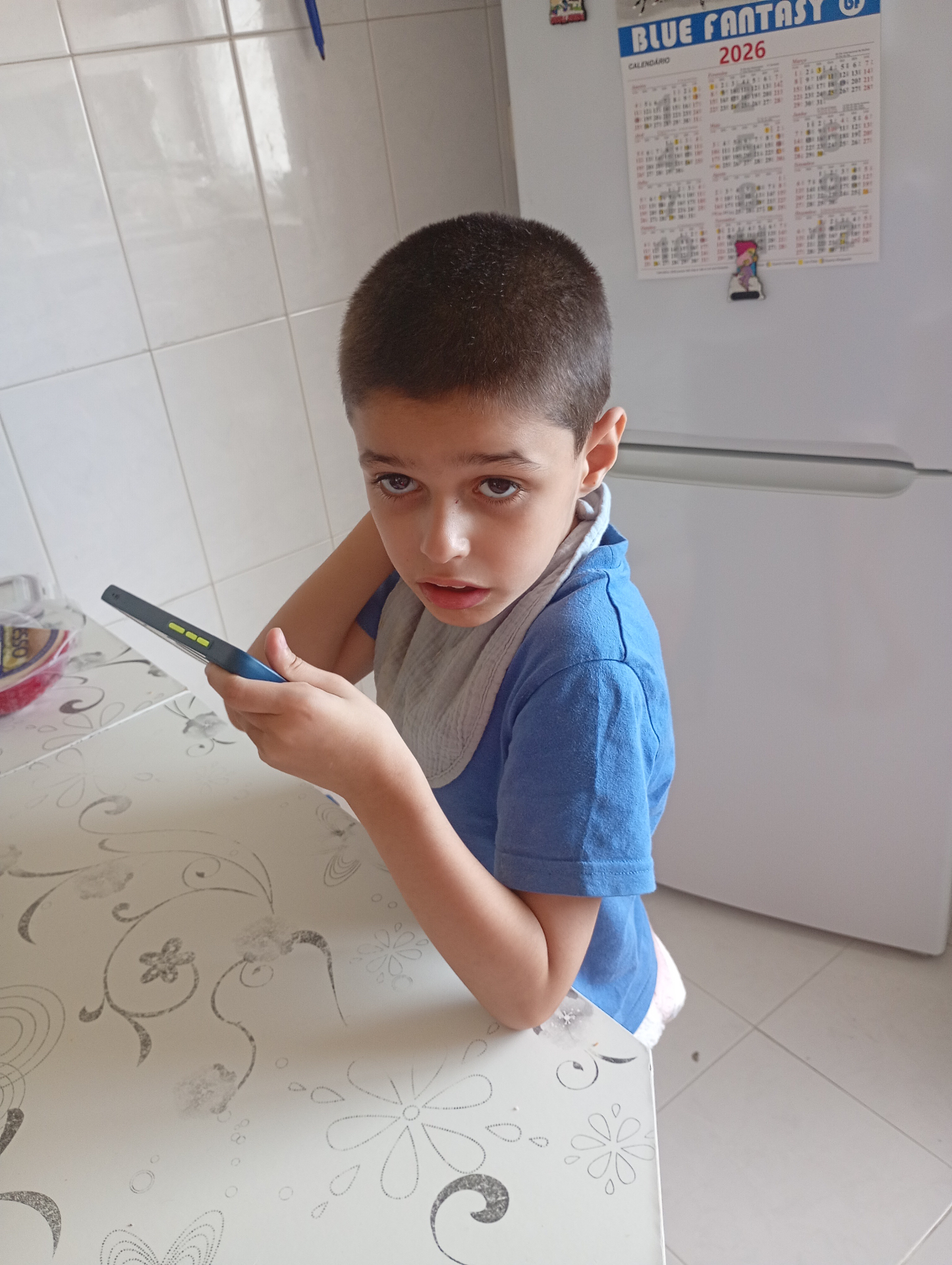 Bruno, a 9-year-old boy, sitting at the kitchen table