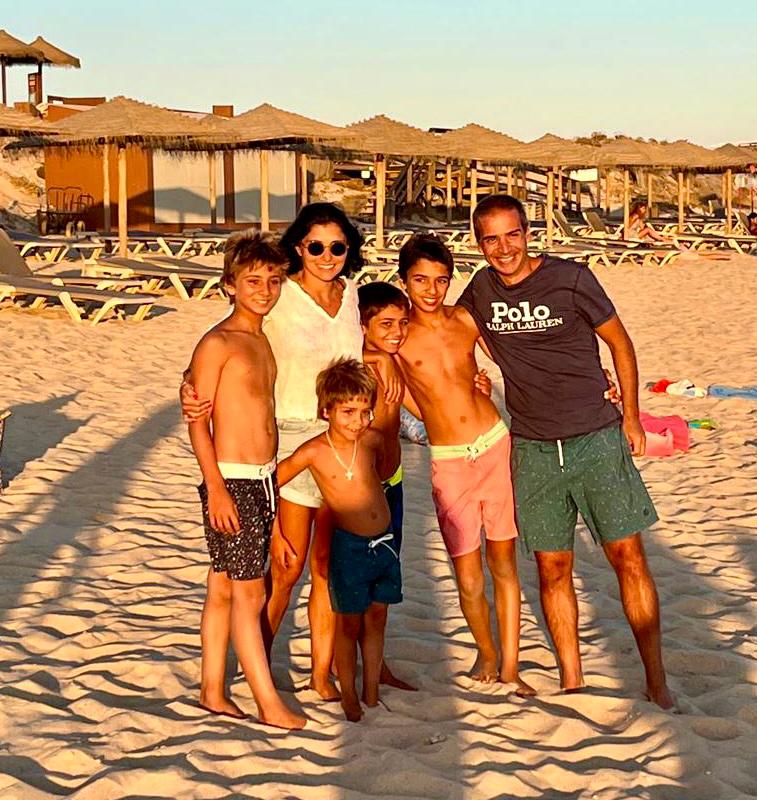 Photo of the founding family of Cure SYNGAP1 Portugal: Henrique, Rita and their four children, on the beach at sunset.