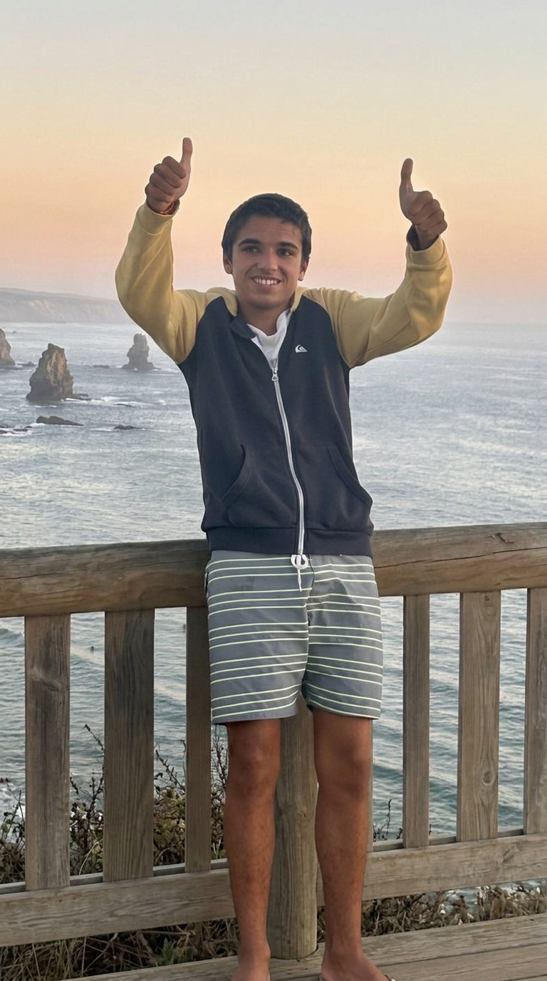 Henrique, Kike, giving a thumbs-up with the sea in the background